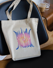 Load image into Gallery viewer, "Change Your Perspective" art quote on a tote bag in a purple gradient