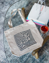 Load image into Gallery viewer, Swirl text effect on a canvas tote bag that says "Creativity Is Contagious"