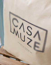 Load image into Gallery viewer, Blurry casa muze logo on a canvas tote bag