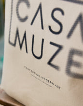 Load image into Gallery viewer, Cas Muze logo with a radial blur effect on a canvas tote bag