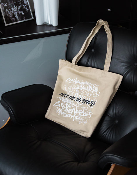 Canvas tote bag with Casa Muze written in graffiti all over with the quote "art has no rules"