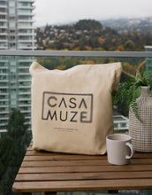 Load image into Gallery viewer, Cas Muze logo with a radial blur effect on a canvas tote bag

