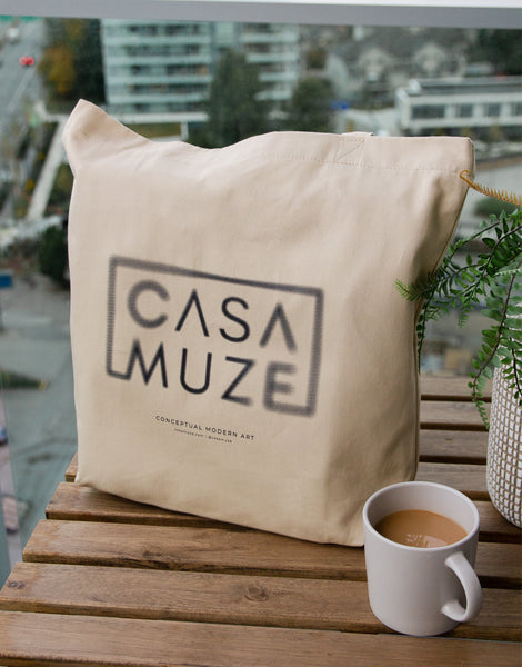 Cas Muze logo with a radial blur effect on a canvas tote bag
