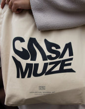 Load image into Gallery viewer, Graphic tote bag design that says Casa Muze with a warped text effect

